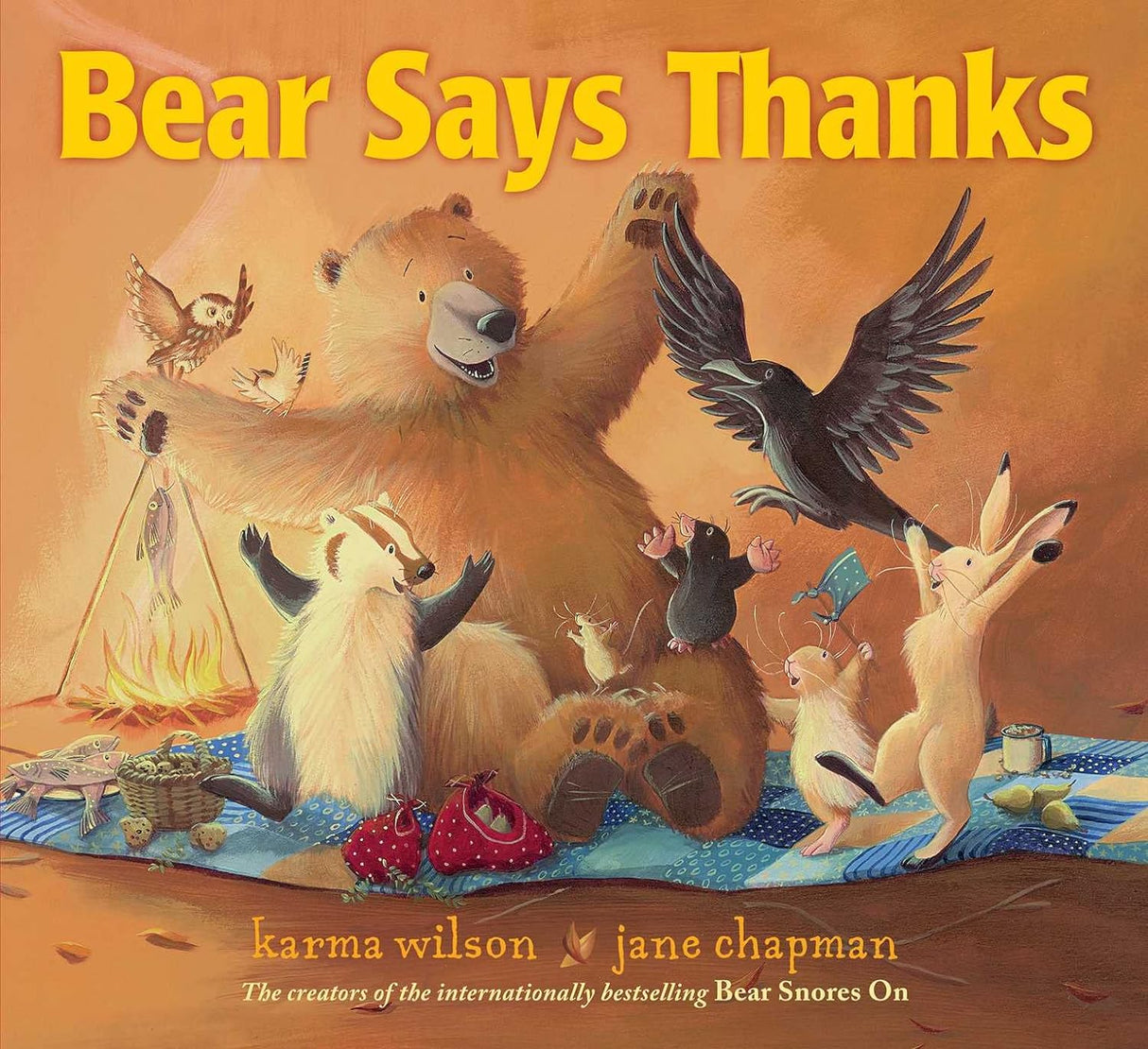 Illustrated cover of Bear Says Thanks showing a happy bear and friends celebrating with food around a campfire.