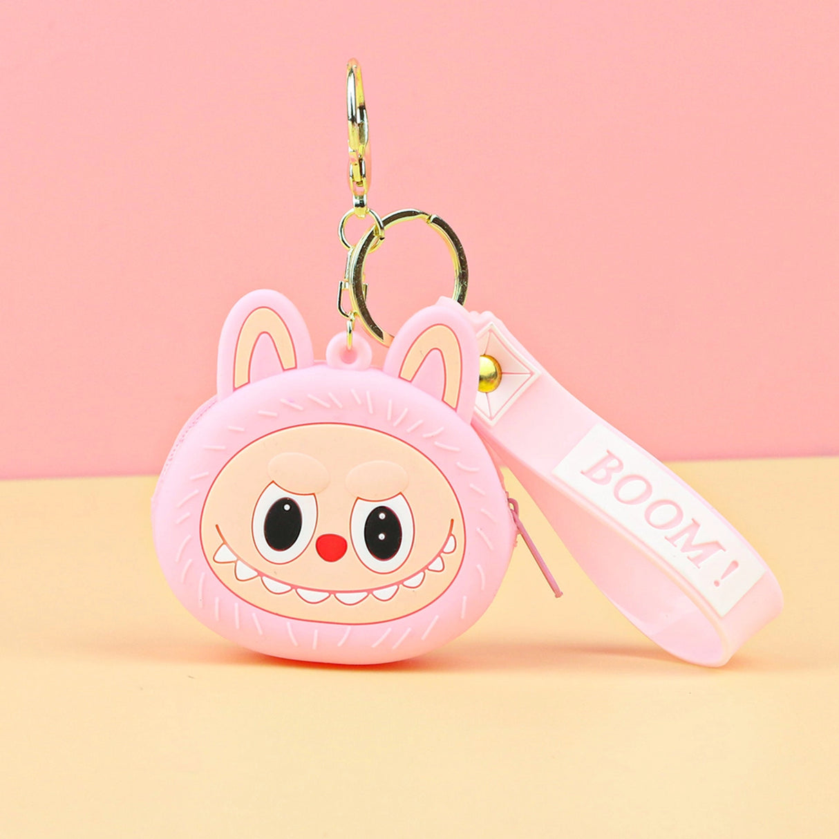 Labubu Head Coin Purse in pink with a cheerful face and keychain strap, perfect for carrying coins securely.
