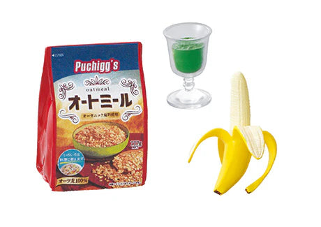 Re-Ment Breakfast Miniature Set showing a tiny oatmeal bag, glass with green drink, and a peeled miniature banana.