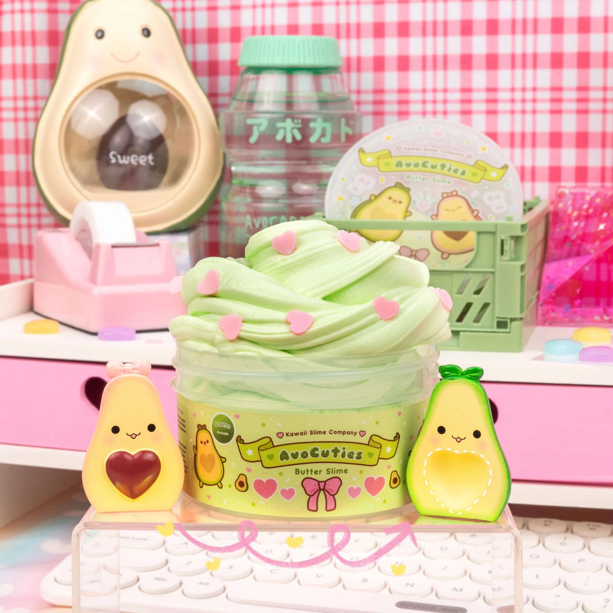AvoCuties Butter Slime with fluffy green slime and cute avocado couple charms on a pastel desk setup.