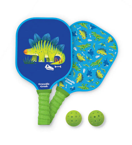 Pickleball | Dinosaur paddle set with colorful dinosaur design, fiberglass paddle, and two green outdoor pickleballs.