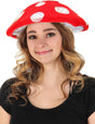 Young woman wearing a red and white Mushroom Lumen Hat with glowing LED lights and adjustable size.