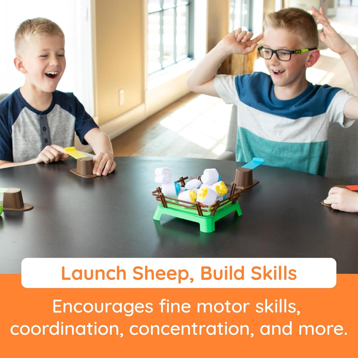 Two boys excitedly play Heap-O-Sheep using springboards to launch sheep onto the hook-and-loop paddock.