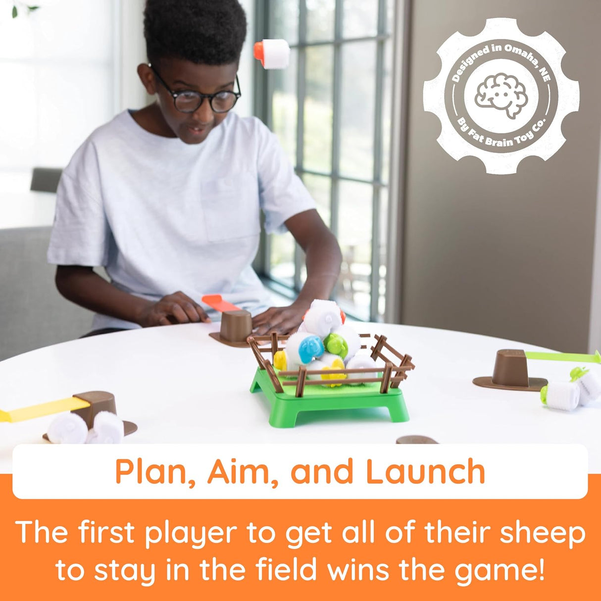Child playing Heap-O-Sheep game, aiming and launching sheep onto the hook-and-loop paddock for a fun stacking challenge.