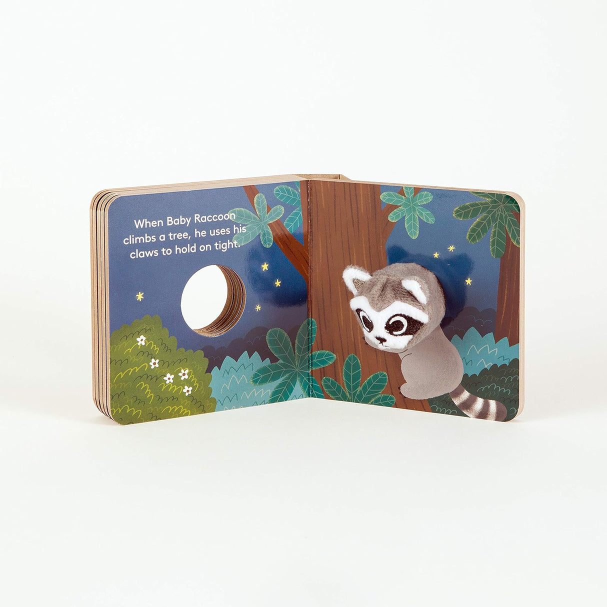 Baby Raccoon BB FIP shows a plush raccoon puppet climbing a tree in a colorful nighttime forest scene.