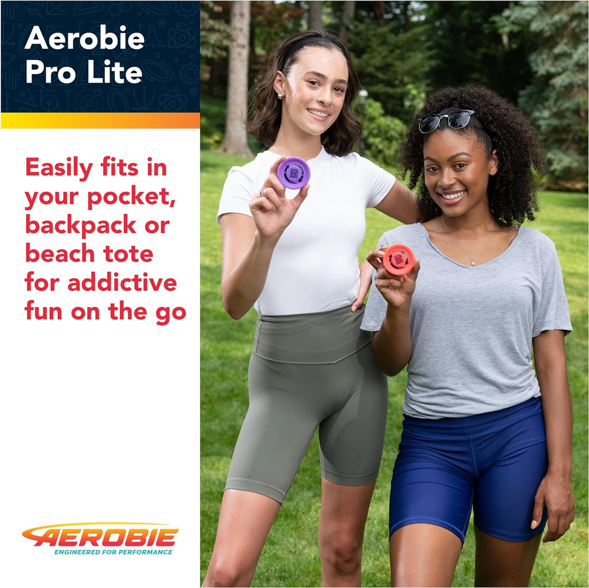 Two women outdoors holding colorful Aerobie Pro Lite miniature throwing discs for fun on the go.