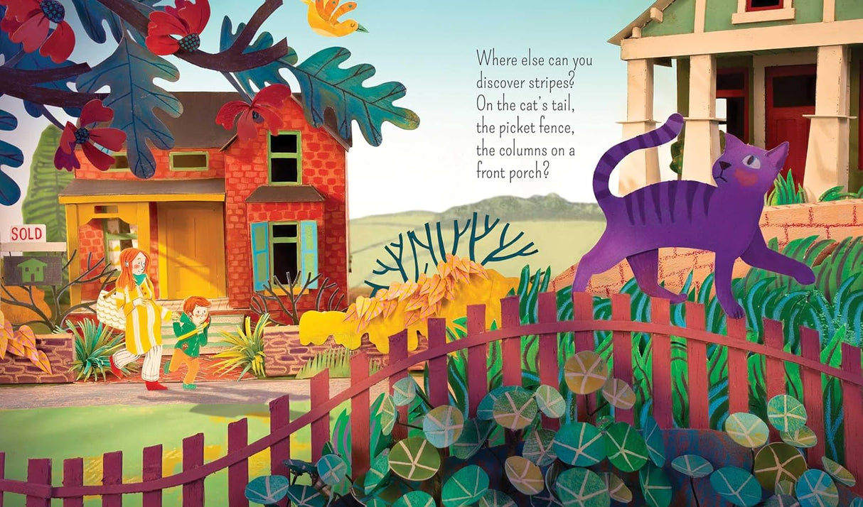 Look book illustration showing a purple striped cat walking on a red picket fence with colorful plants and houses in the background.