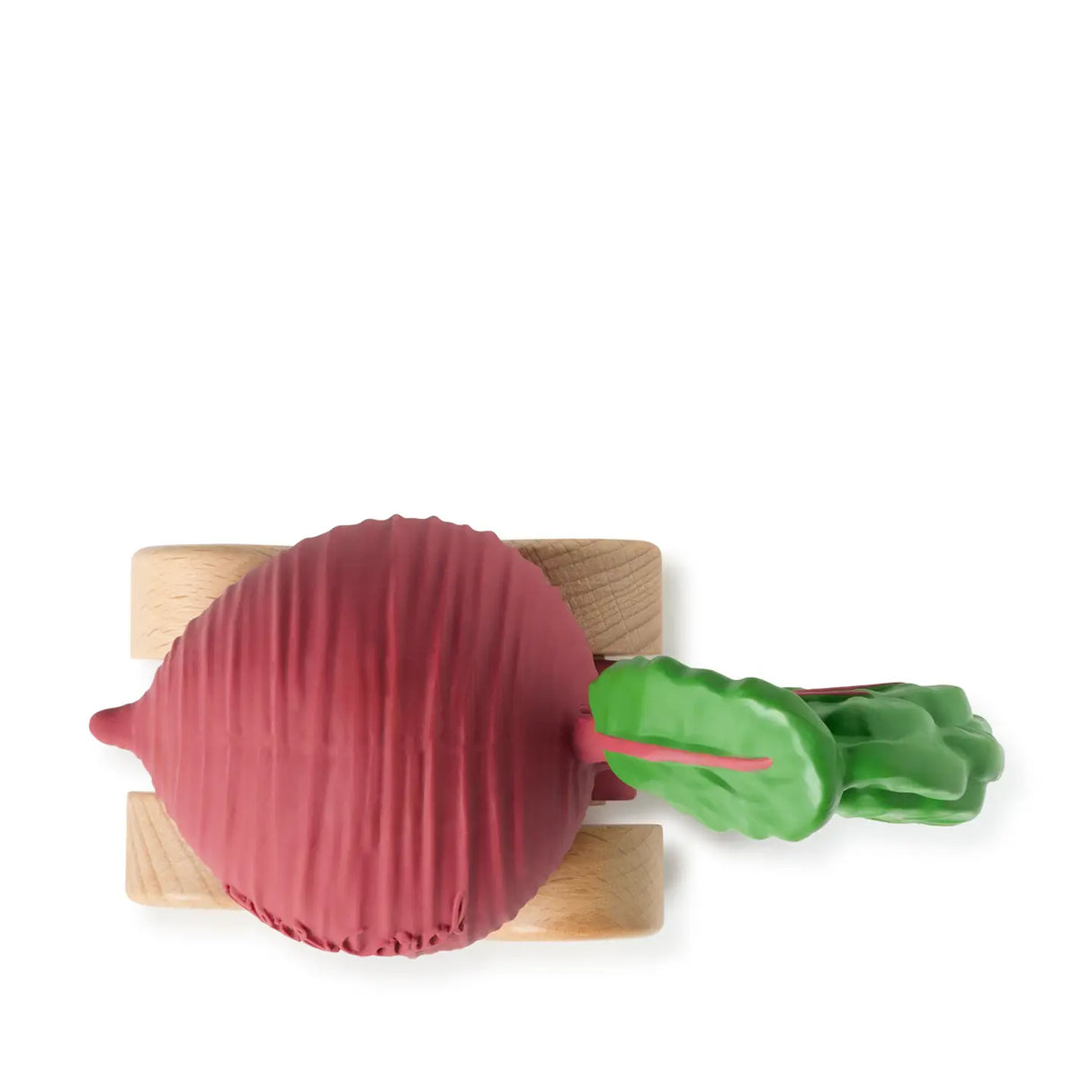 Top view of a baby car toy shaped like a red beet with green leaves on wooden wheels against white background