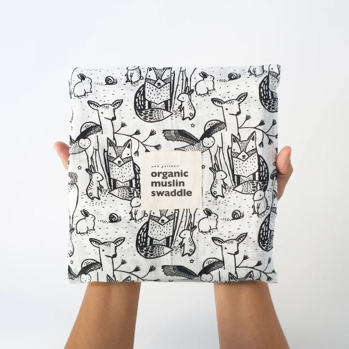 Organic Muslin Swaddle | Forest showing black and white animal prints made of 100% organic cotton muslin fabric.