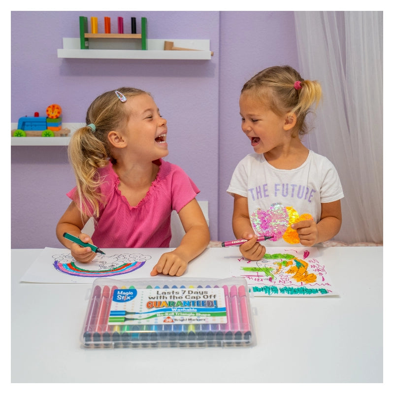 Two young girls coloring happily using Magic Stix Markers 12pc with vibrant, washable, non-toxic colors on paper.