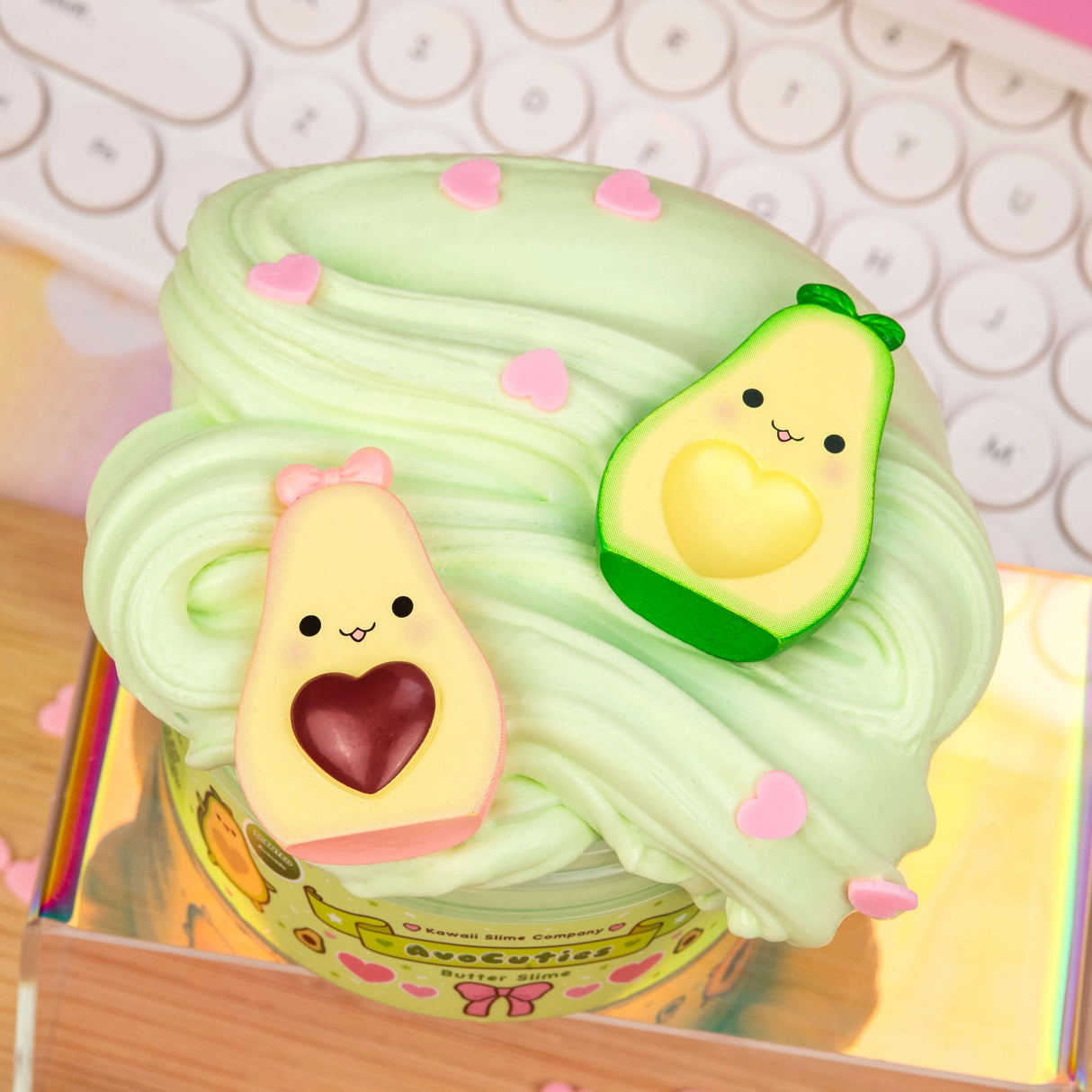 AvoCuties Butter Slime with fluffy light green slime and cute avocado couple charms on top.