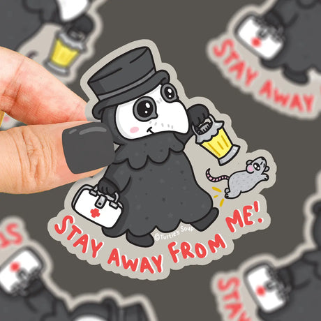 Hand holding a durable vinyl sticker of a cute plague doctor with a lantern and rat saying stay away from me