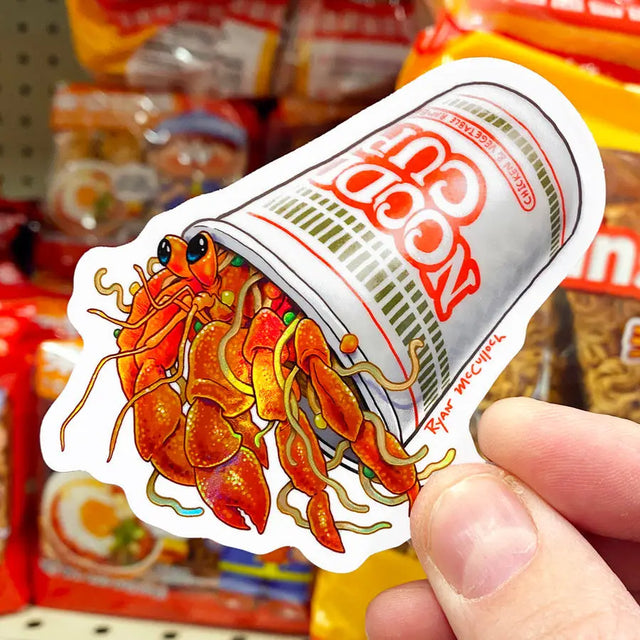 Ramen Hermit Crab Sticker showing a colorful crab inside a instant noodle cup, waterproof and durable vinyl design.