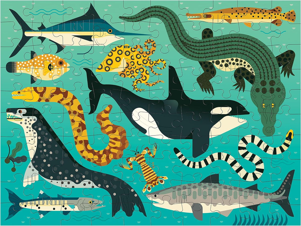 100pc Land & Sea Predators Double-Sided Puzzle showing colorful ocean predators on a completed puzzle with vibrant blue background.