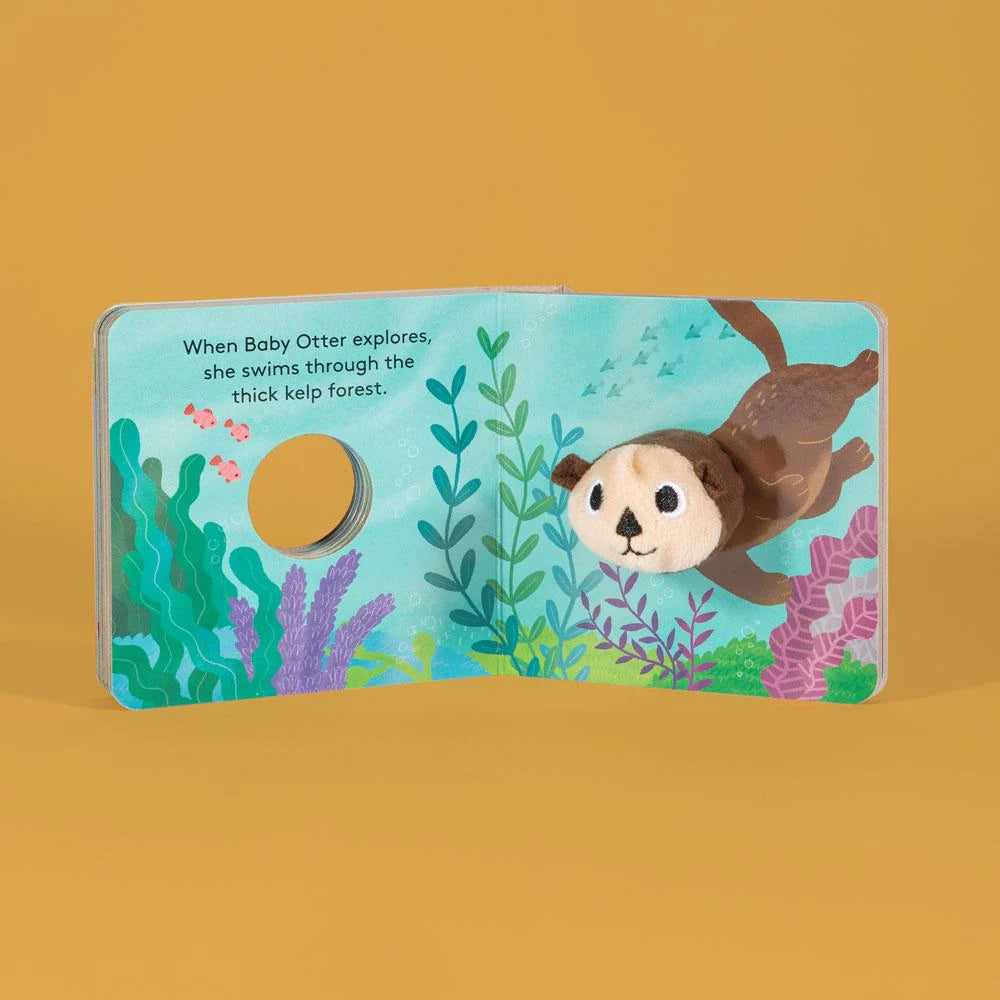 Baby Otter with Finger Puppet board book showing plush otter puppet swimming in illustrated kelp forest.