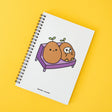 Grumpy Chicken Potato Mode Notebook with spiral binding and cute potato characters on white cover against yellow background