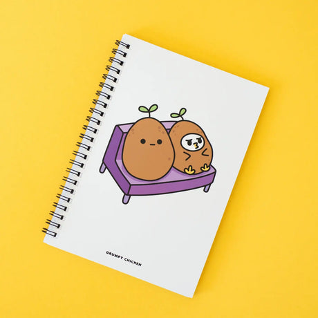 Grumpy Chicken Potato Mode Notebook with spiral binding and cute potato characters on white cover against yellow background
