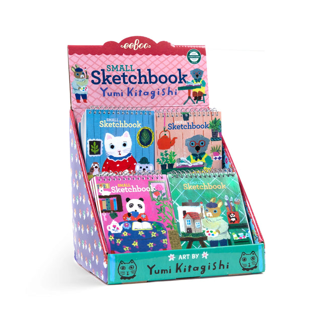 Small Sketchbook | Yumi Kitagishi display with colorful, spiral-bound sketchbooks featuring playful animal artwork.