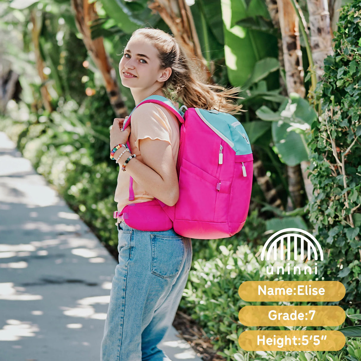 Girl wearing Backpack | Pink & Teal Color Block with padded straps and ample storage, walking outdoors on a sunny day.