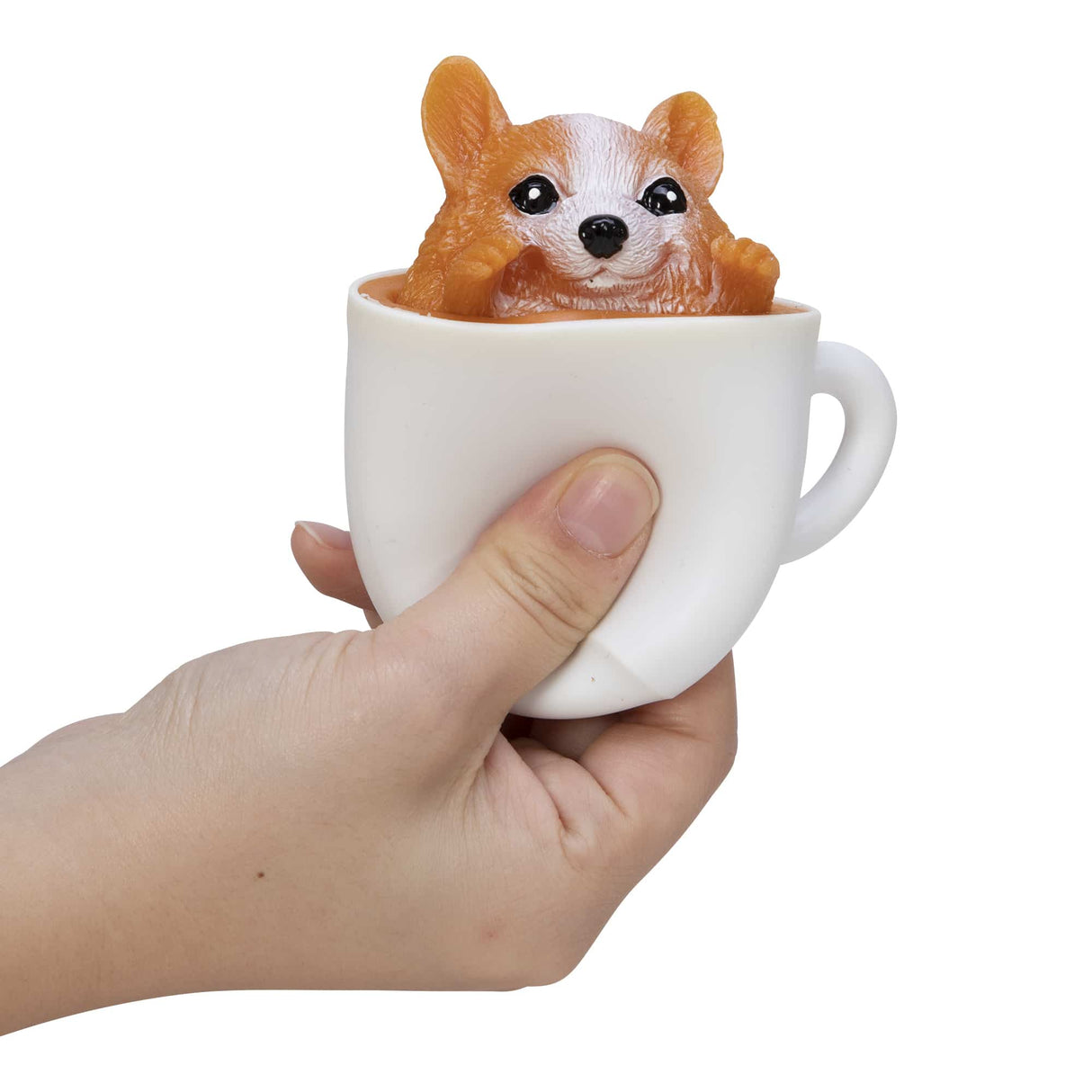 Hand squeezing a white cup with a cute corgi pup inside from the Pup in a Cup! collection.