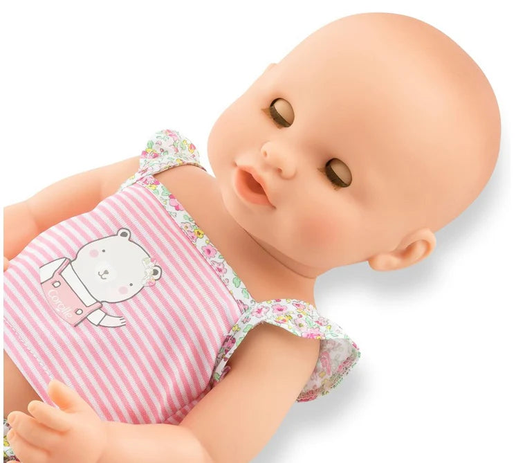 Drink & Wet Emma baby doll with sleeping eyes, wearing pink striped outfit, showcasing realistic soft vinyl body.