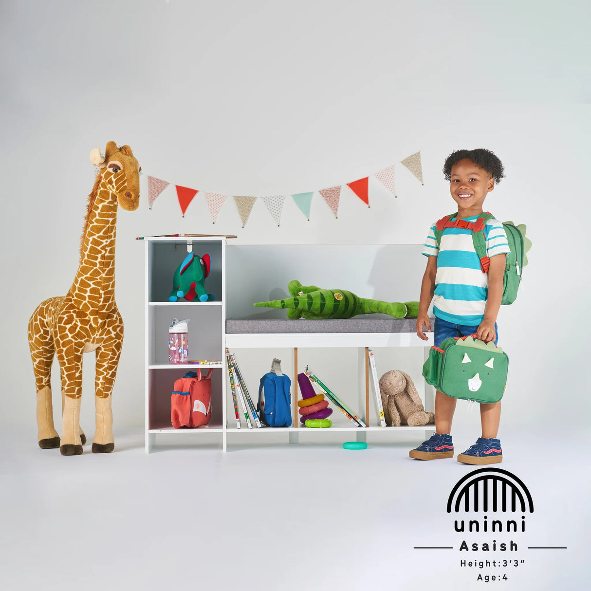 Toddler Lunchbag Dinosaur held by smiling child, fully insulated with padded handle and versatile storage compartments.