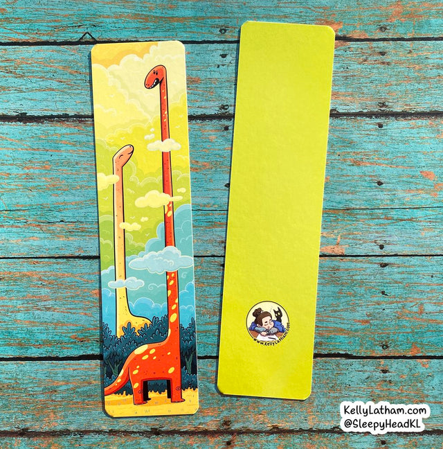Dinosaur Clouds Bookmark showing colorful dinosaurs with heads in clouds on high gloss coated paper.
