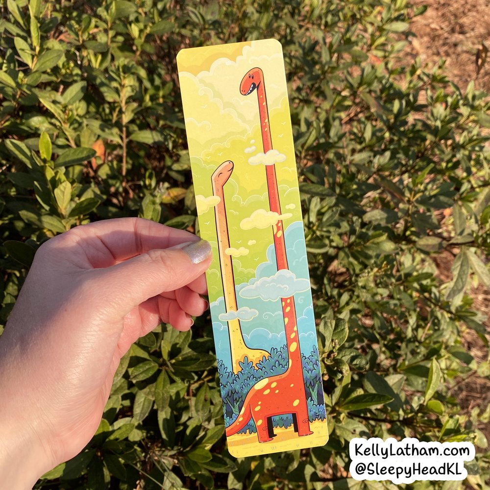 Dinosaur Clouds Bookmark showing two long-necked dinosaurs with their heads in clouds against a colorful sky background.
