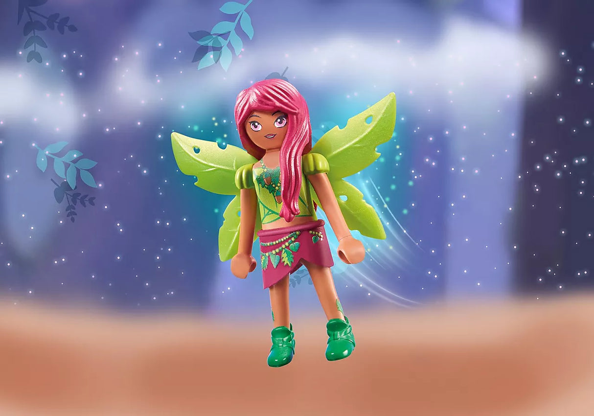 Ayuma | Forest Fairy Leavi toy figure with green wings, pink hair, and magical forest background.