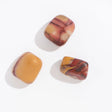 Three 1-inch polished stones with soft matte finish, showcasing warm earthy hues in Rock | Matte Tumbled Mookaite Crystal.