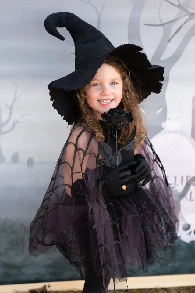 Child wearing Spider Witch Tutu & Cape | Size 5-6 with spider web overlay tutu and matching cape.