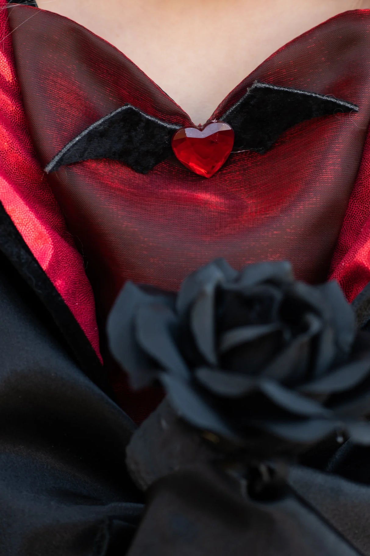Vampire Dress | Size 5-6 close-up of red lace bodice with bat detail and black rose on elegant vampire collar.