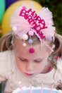 Happy Birthday Headband with pink tulle, pom pom strings, and festive lettering for kids' birthday parties.