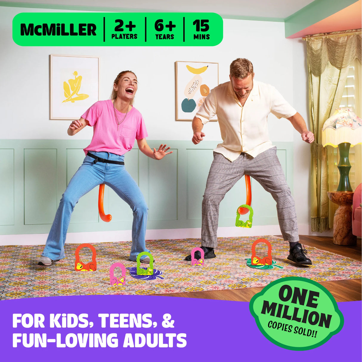 Two adults playing It’s Bananas party game wearing monkey tails, collecting colorful banana tokens indoors.