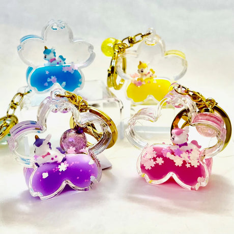 Unicorn Flower Keychain with colorful liquid, glitter, and miniature unicorn inside flower-shaped charm clip.