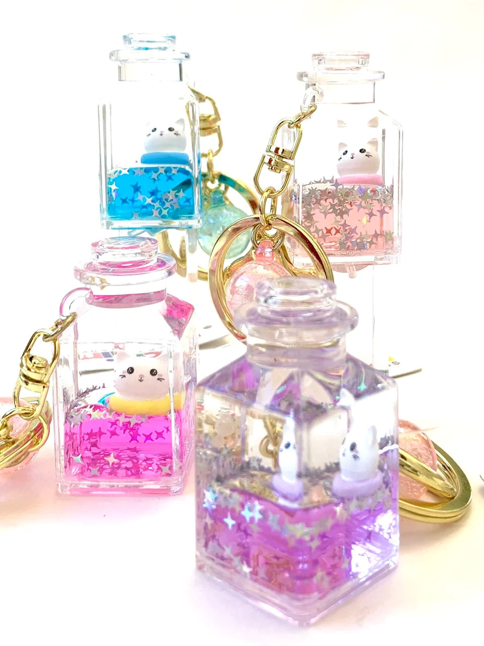 Kitty Jar Floaty KeyChain with assorted colorful liquid and cute cat figures inside clear jar keyrings.