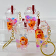 Capybara Boba Floaty Keychain with colorful beads inside clear cup charm and gold keyring, assorted styles shown