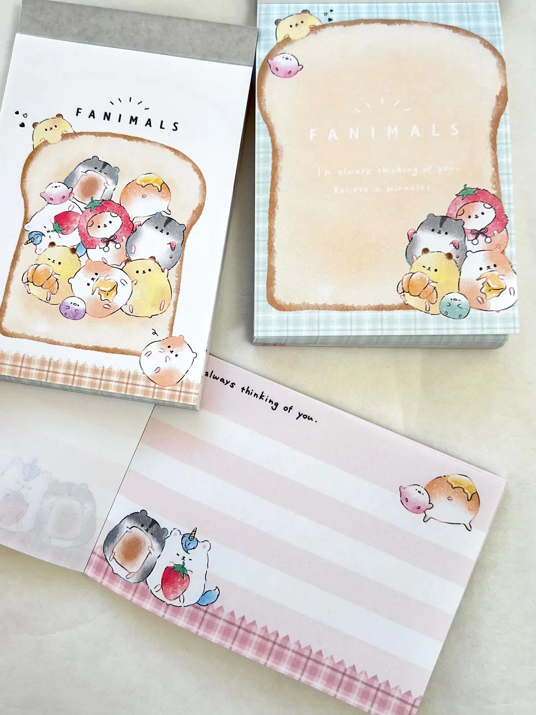 Mini Notepad | Fanimals Animal Toast with colorful animal illustrations on toast-shaped pages, pocket-sized for notes or doodles.