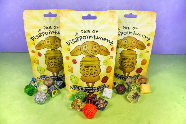 Three Dice of Disappointment Bags displayed with mismatched, funny acrylic and cursed DnD dice sets.