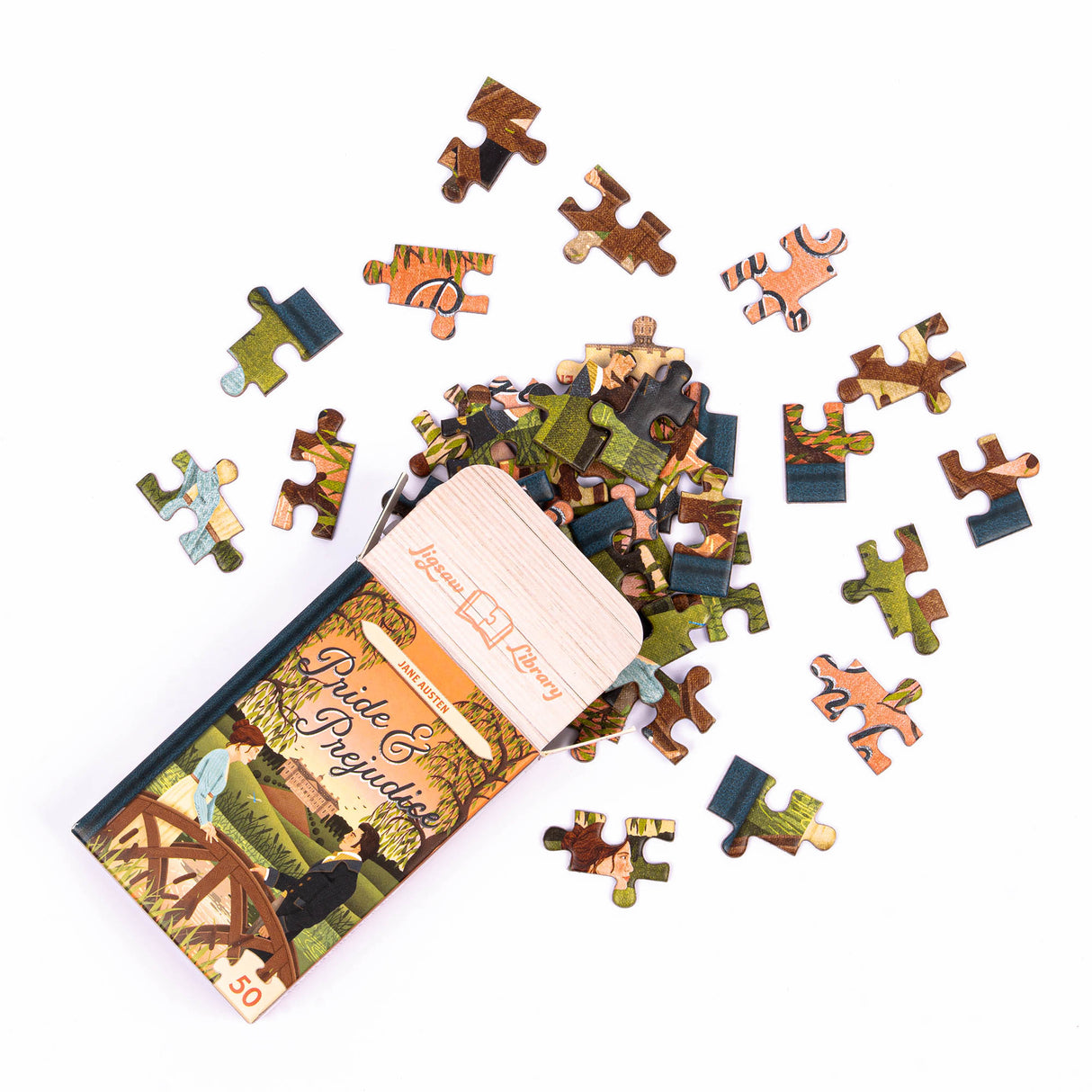 50pc Mini Library Puzzle featuring Pride & Prejudice cover with loose, colorful puzzle pieces in a small box.