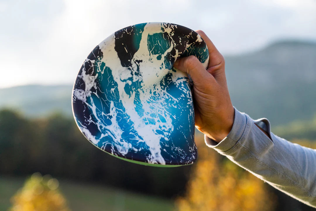 Waboba Wingman Disc PRO in hand outdoors showing flexible, foldable 8.2 inch silicone flying disc with unique design.