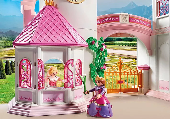 Princess | Castle toy with pink-roof tower, princess figures, and ornate golden gate in a royal setting.