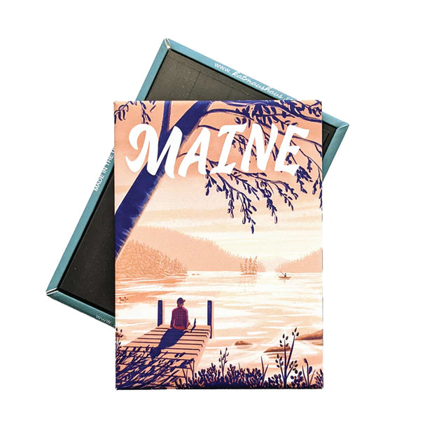 Maine Dock Magnet showing a peaceful lakeside scene with a person sitting on a dock at sunset.
