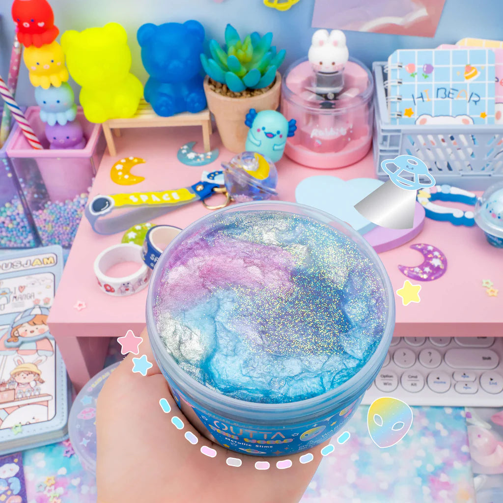 Outta This World Metallic Slime in shimmering pink, blue, and silver with interstellar charms and starry sprinkles.