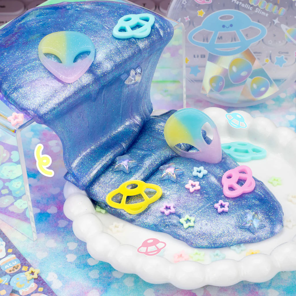 Outta This World Metallic Slime with metallic blue shimmer, alien charms, and starry sprinkle mix for sensory fun.