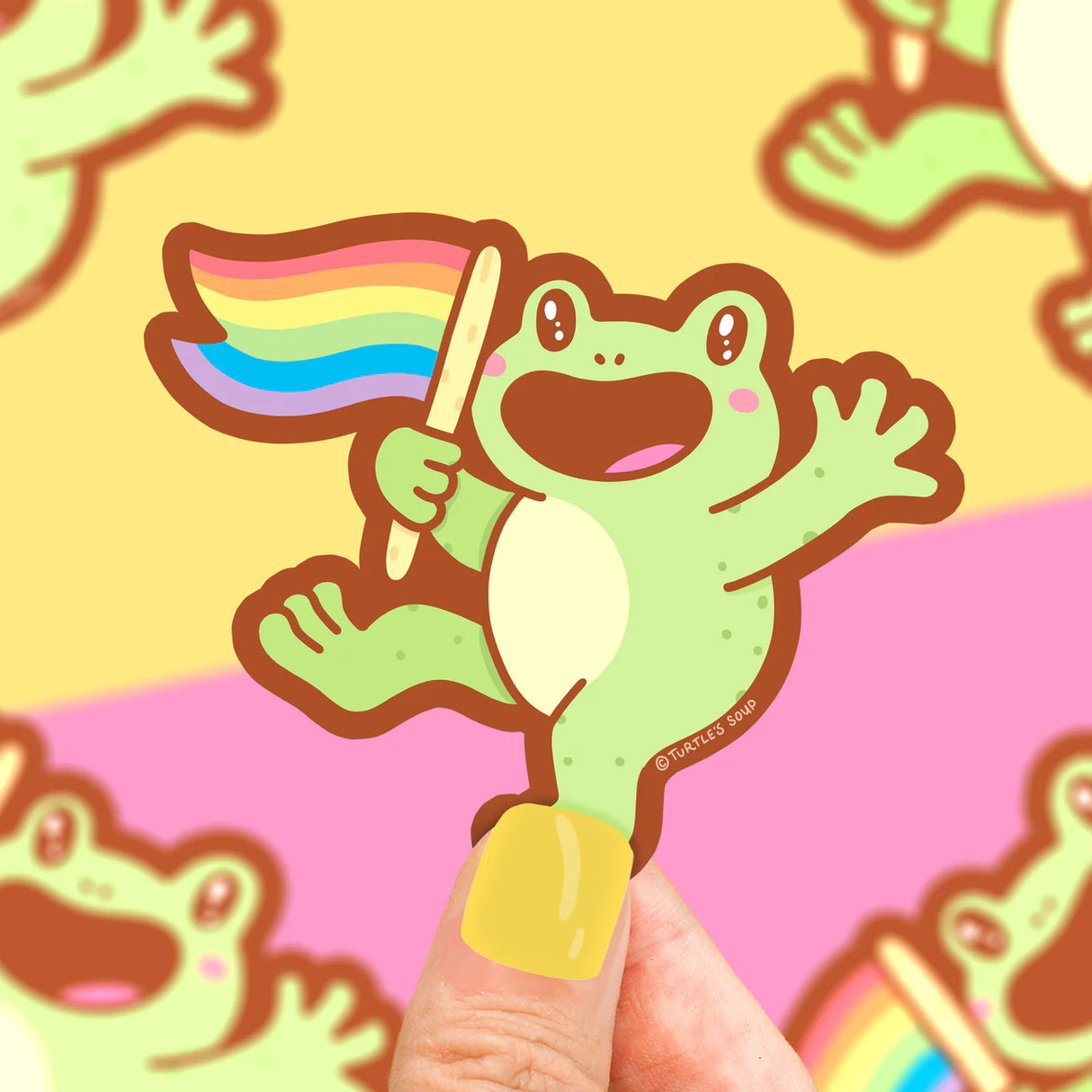 Rainbow Frog Sticker showing a happy green frog holding a waving rainbow pride flag on a colorful background.