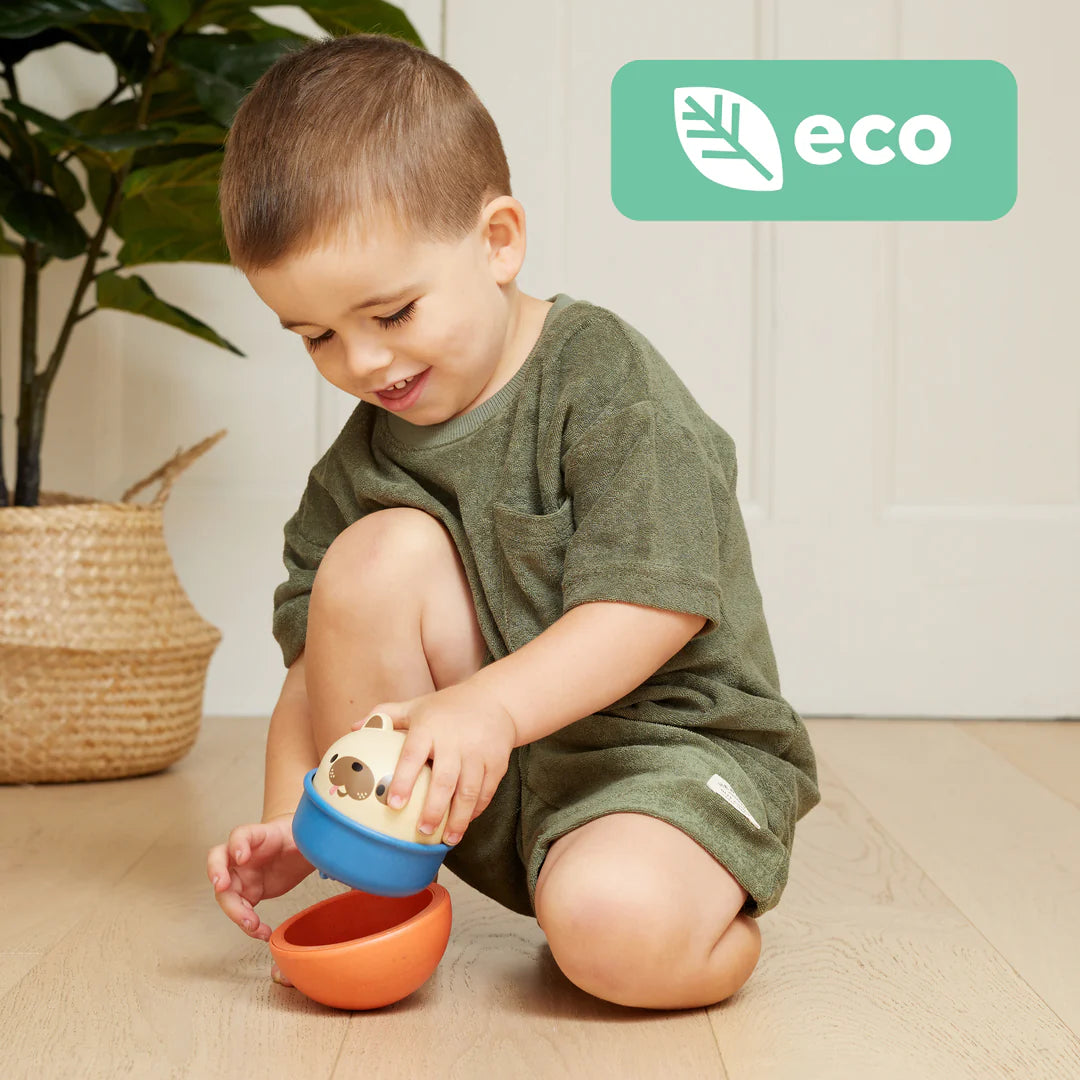 Child playing with eco-friendly Rocking Rollers Dog toy, which rocks and glides on wheels for fun playtime.