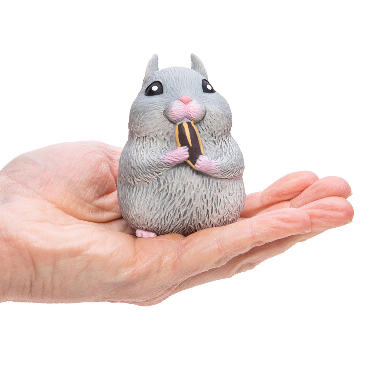 Chonky Cheeks Hamster squishy toy held in hand, gray hamster nibbling on a snack, about 3 inches tall.