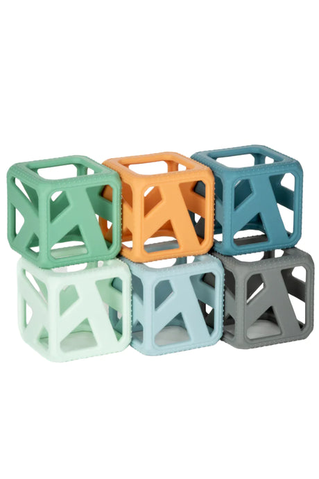 Stack & Chew Earthy Cubes in various colors, soft silicone developmental teething toys for babies to stack and chew.