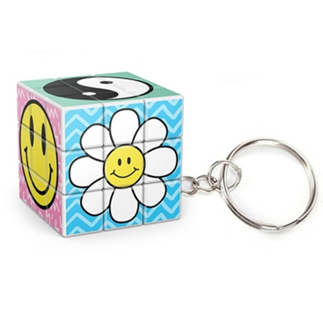 Cube-Dini Mini: Totally 90's Keychain showing a colorful puzzle cube with smiley face, flower, and yin-yang designs.